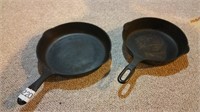 Two larger cast iron skillets