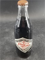 Vintage Coca Cola bottle commemorative seal on bac