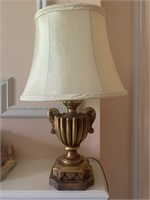 Gold mantel lamp with urn shape and cream shade