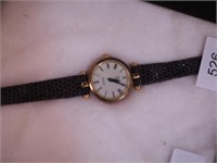 Woman's watch with Gucci logo on back, letters