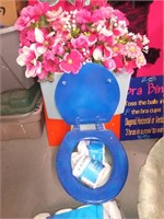 Blue toilet with floral used for toilet paper