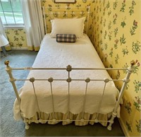 Antique twin size iron bed with bed linens