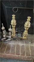 Two pair of brass fireplace andirons, the larger