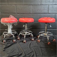 3 red wheeled stools