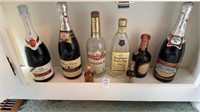 Shelf a lot of liquor bottles such as Seagrams