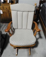 Open arm glider rocker with upholstered cushion