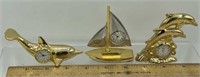 3 Miniature brass clocks, dolphins and a sail boat