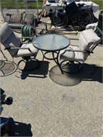 Circular outdoor table with 2 chairs and cushions