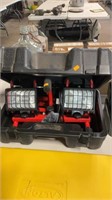 Two halogen work lights on stand in case