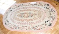 Vintage pink and white floral oval hooked rug
