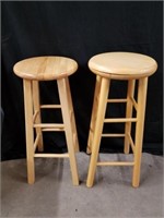 Two wood stools one of them is a swivel top the
