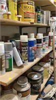 Full shelf of spray paints, paint, roof cement