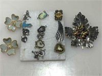 Assorted fashion jewelry charms and pins.