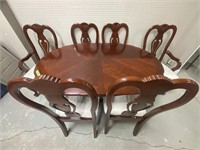 Oval wooden dining room table and six chairs with