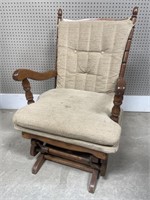 Gliding wooden rocker with cushions. Upholstery