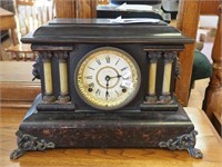 Vintage striking black mantel clock by