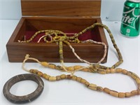 Wooden box with miscellaneous necklaces and stone