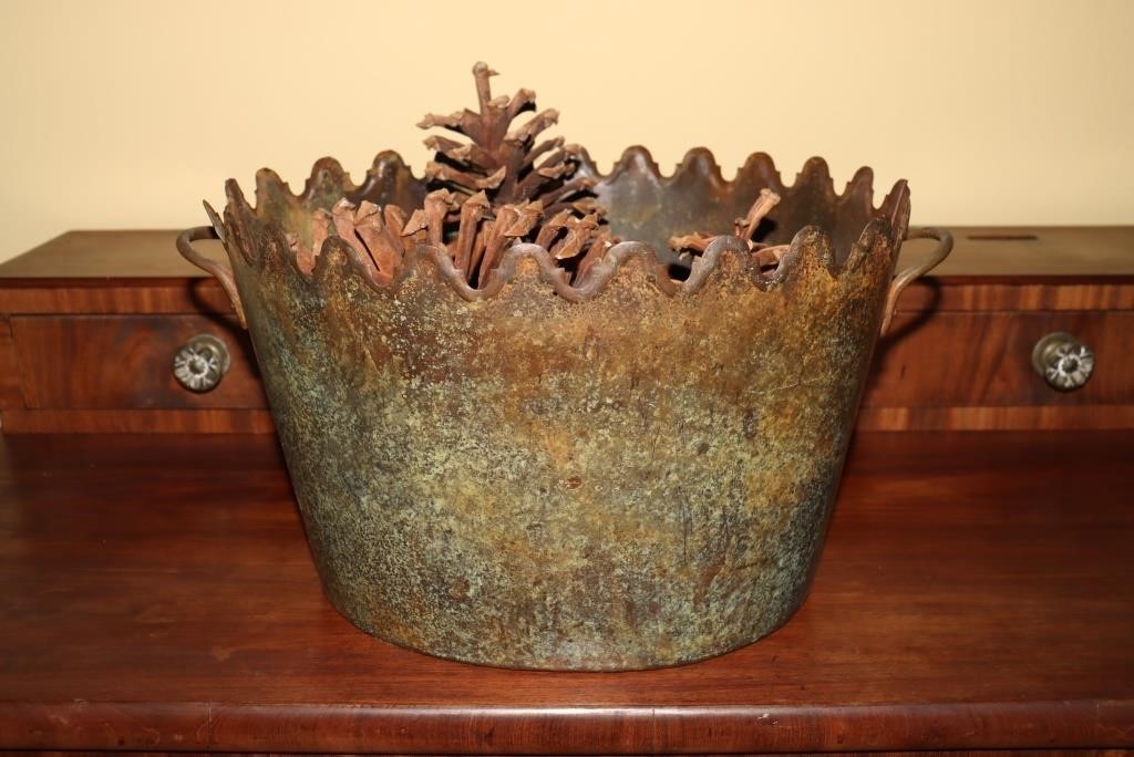 Tin flower pot containing pine cones