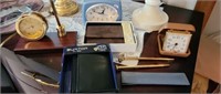 Group of clocks, wallets, and pens