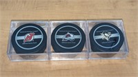 3 Various Official NHL Hockey Pucks in Case