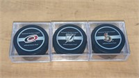 3 Various Official NHL Hockey Pucks in Case