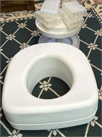 Raised toilet seat and medicine containers
