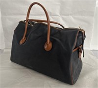 Designer-style leather duffel bag labeled