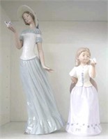 Two girl holding butterfly figurines