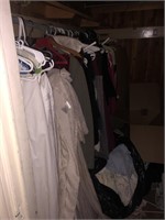 Closet full of clothes and vintage curtains