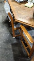 Wooden kitchen table with 5 chairs on rollers