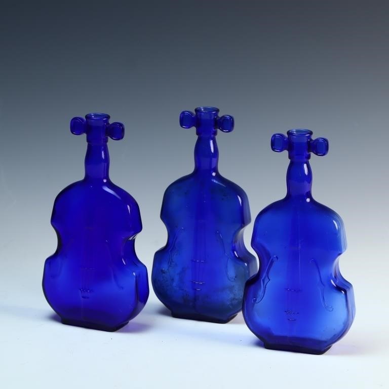 Three blue cobalt guitar bottles