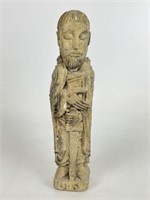 Carved Stone Figure with Sword and Book