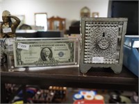 Cast iron Treasury Safe still bank and a U.S. $1