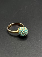 Gold toned costume ring with blue stones