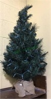 Small artificial Christmas tree with burlap