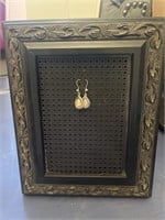 Earrings and a metal frame to display them