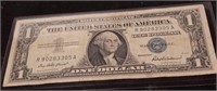 1957 $1 Silver Certificate with a protective