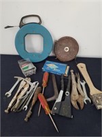 Group of tools and a vintage tape measure