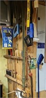 CONTENTS OF WALL: CARVING TOOLS, SAWS, WHIP &