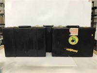 Three vintage black suitcases