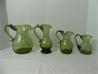 4 GREEN GLASS PITCHERS