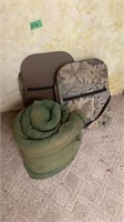 Green sleeping bag and camo hunting chairs