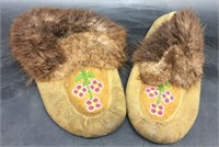 Pair of tanned, beaded slippers with beaver fur tr