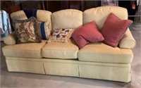 Yellow Highland House sofa with accent pillows