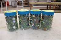 (4) plastic jars of marbles