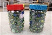 (2) plastic jars of marbles