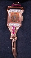 A woman's rose gold 14K diamond and ruby