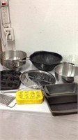 Group of kitchen items mixing bowls strainer