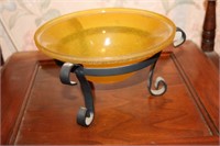 Yellow textured bowl in wrought iron stand