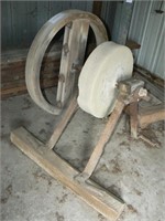 Belt-driven grinding stone on stand